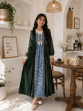 Junior girl wearing a modest green velvet and blue patterned full-length maxi dress with lace details, standing in a cozy café interior with elegant décor.