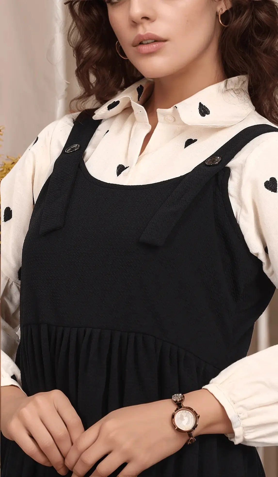 Stylish Black and White Pinafore Dress featuring adjustable straps and a pleated skirt for a chic look