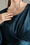 Close-up of a woman's hand on a blue satin flare modest gown by YEZWE showcasing luxurious fabric