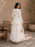 Woman in Ivory Faux Georgette Asymmetric Ruffle Maxi Dress with lace-up back detail