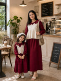 Maroon CEY Fabric Mother Daughter Combo Dress With Hakoba Layer in a cozy café setting