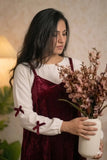 Maroon Velvet Sleeveless Gown with Knitted Inner | Modest Maxi Dress for Women styled with floral arrangement.