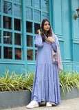 Modest sky blue maxi dress with long sleeves and layered design, styled with a matching scarf.