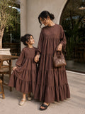 Mom and daughter matching tiered maxi dress set in brown stripes, perfect for stylish outings together