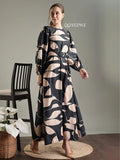 Elegant black abstract print modest maxi dress by YEZWE, featuring a belt and long sleeves