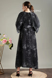 Back view of black floral print belted modest maxi dress by YEZWE with flowing sleeves