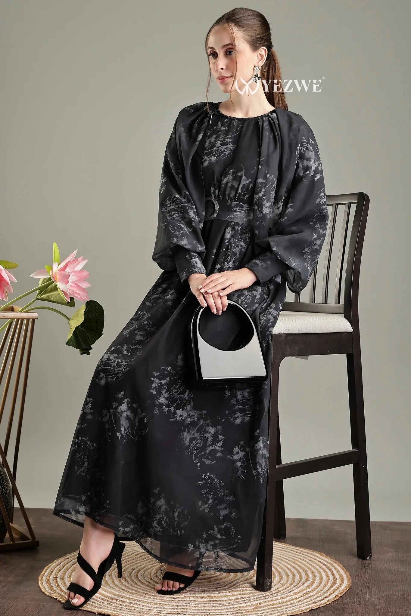 Elegant black floral print belted modest maxi dress from YEZWE, styled with a black handbag and heels