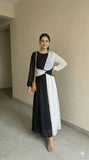 young woman wearing a black and white dual tone modest maxi dress walking pose full length indoor view