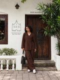 YEZWE Dark Brown Premium Linen Wrap Top Modest Co-Ord Set For Women styled with a black handbag near a rustic door