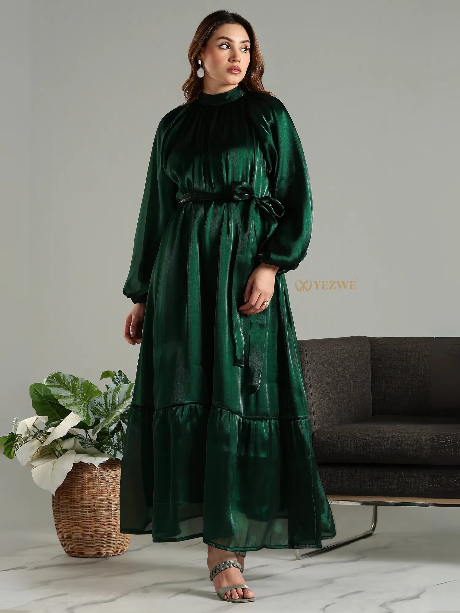 Yezwe emerald green modest maxi dress with long sleeves and waist tie detail on a model