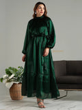 Yezwe emerald green modest maxi dress with long sleeves and waist tie detail on a model