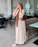 YEZWE modest Occasion wear beige flare dress styled with a brown hijab in a chic indoor cafe setting