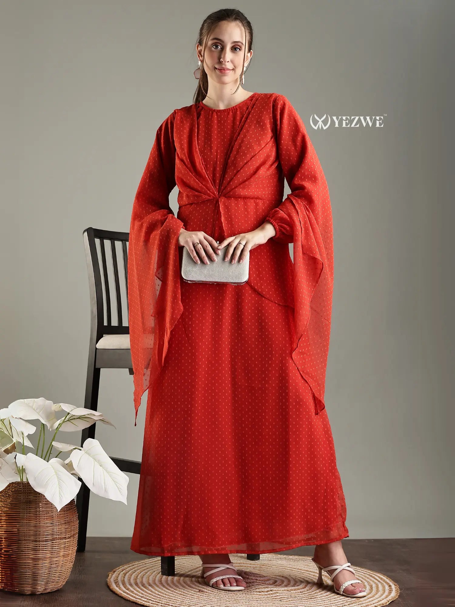 Modest in orange georgette maxi dress with elegant sleeves and stylish pleating, perfect for special occasions
