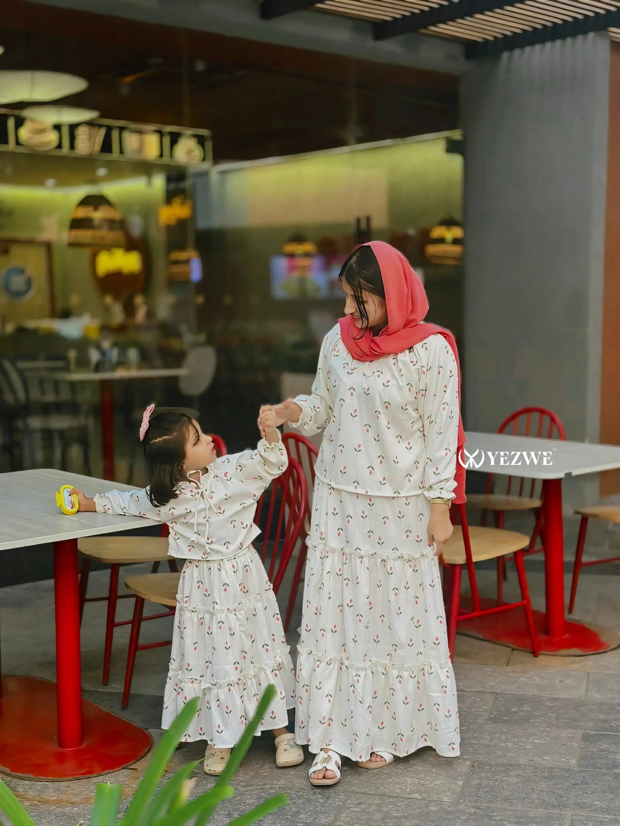 Modest Korean oneset outfit for women and girls featuring matching floral patterns and playful design