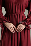 Modest long sleeve maxi maroon dress by YEZWE with elegant detailing and cinched waist