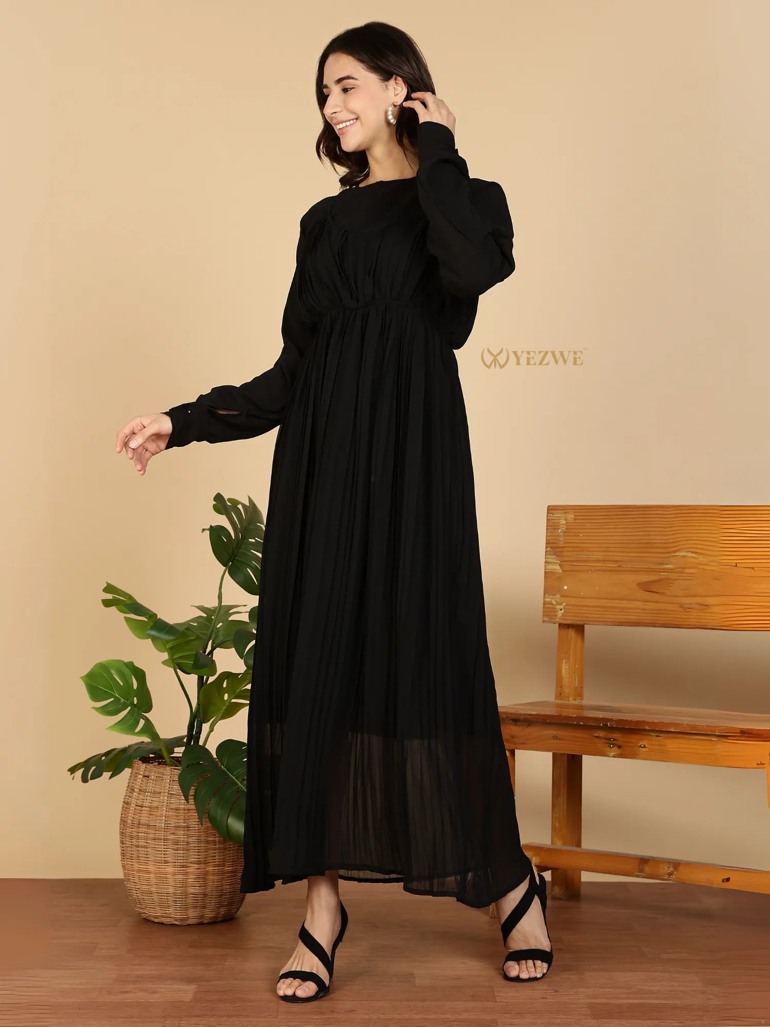 YEZWE black Modest Maxi Dress with long sleeves pleated skirt and empire waist worn by smiling model