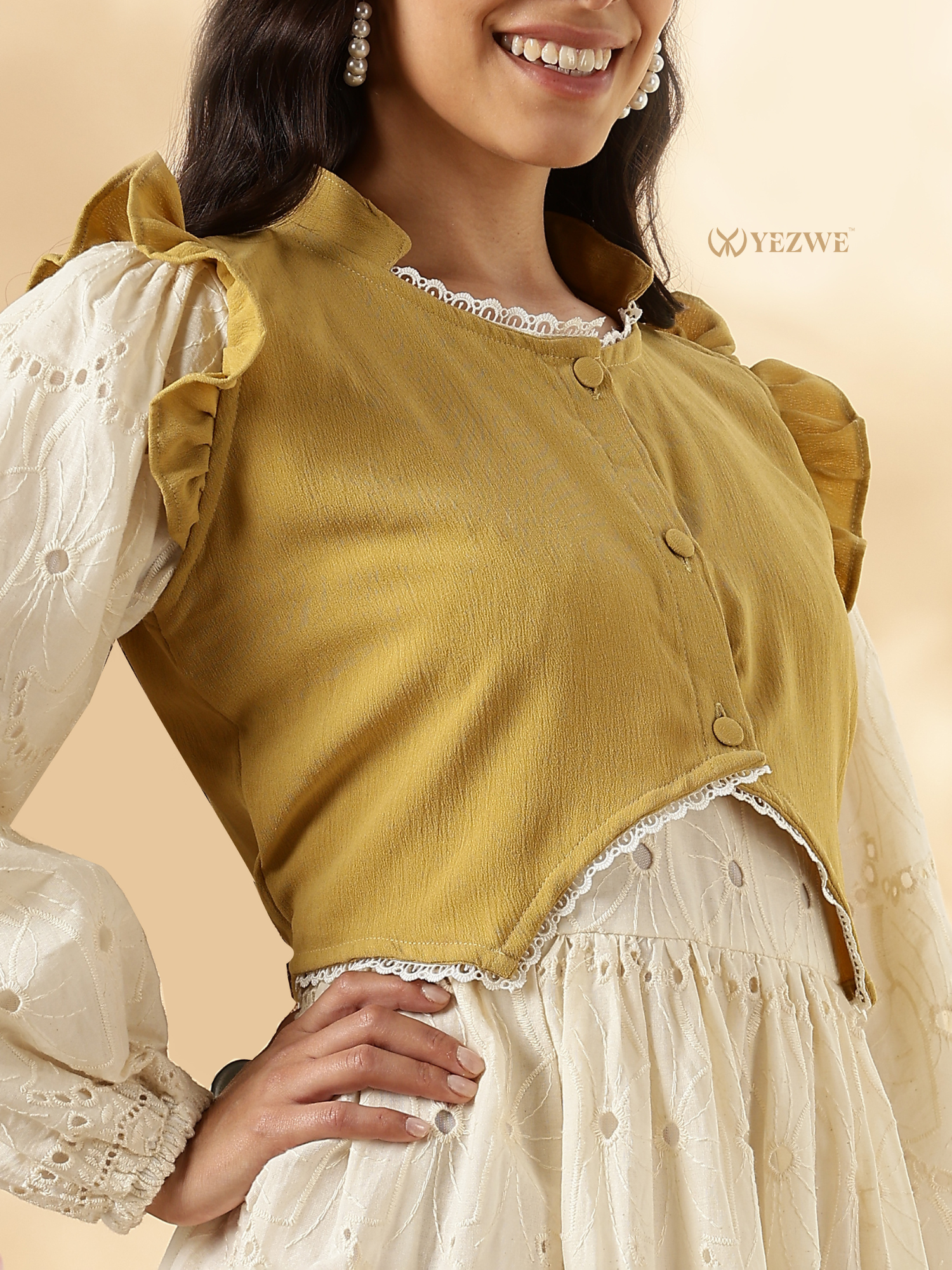 Yellow cropped jacket paired with a white modest maxi dress featuring ruffled sleeves and lace details