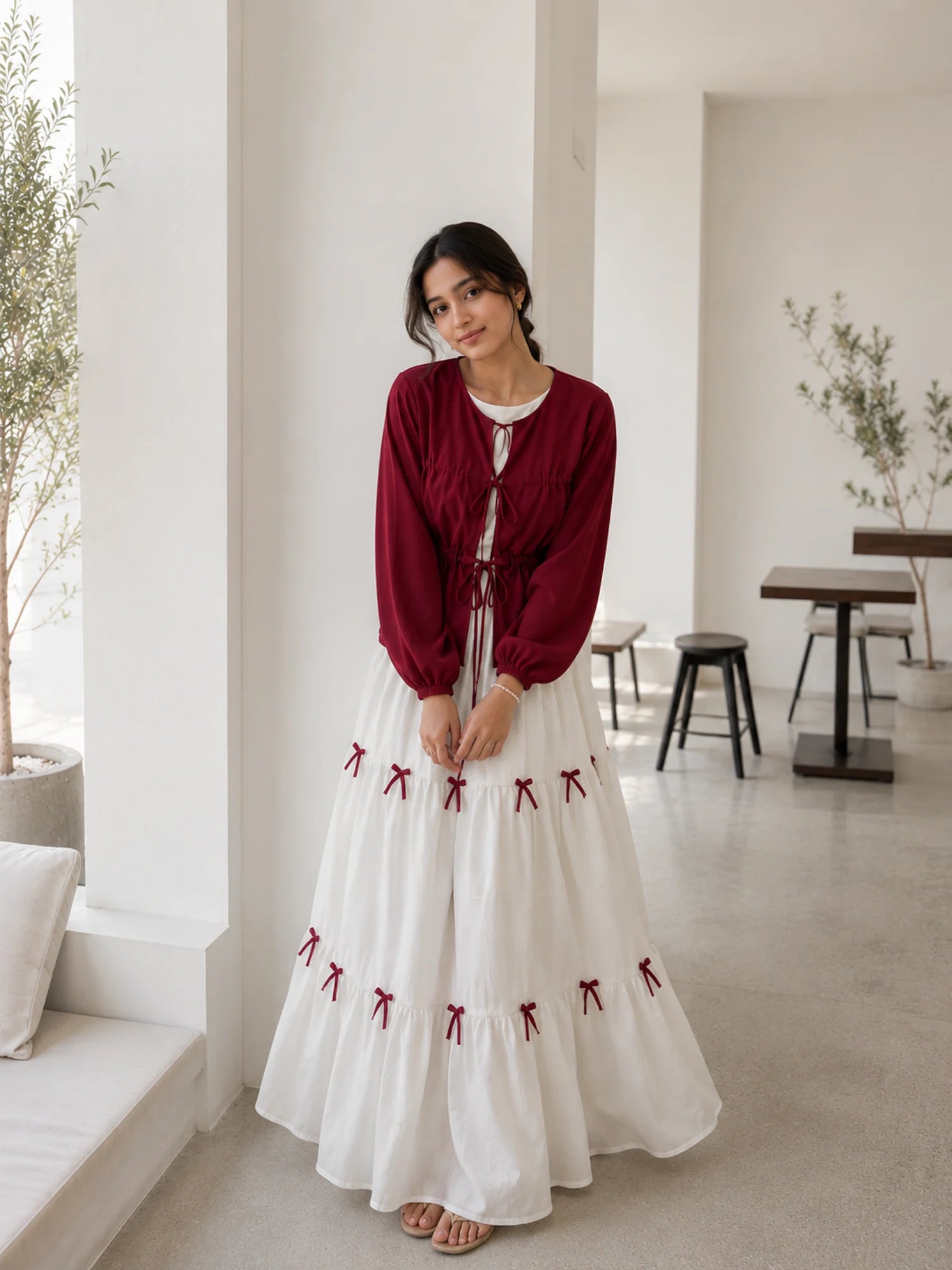 Pinterest Bow Detail White Flared Gown with Wine Cey Shrug | Yezwe Modest Wear in a bright indoor setting