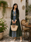 Junior girl wearing a modest green velvet and blue patterned maxi dress with long sleeves, holding a woven handbag in an elegant outdoor café setting.