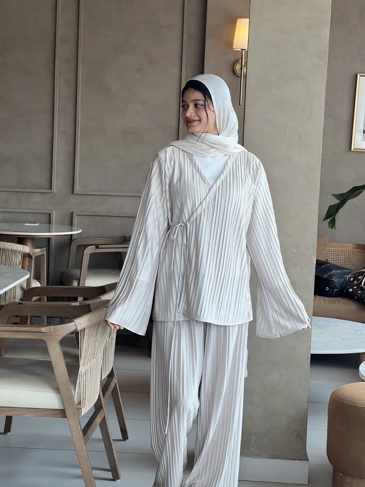Back view of beige striped co-ord set for women with long sleeves and wide pants, styled with hijab for a modest and elegant look
