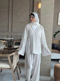 Back view of beige striped co-ord set for women with long sleeves and wide pants, styled with hijab for a modest and elegant look