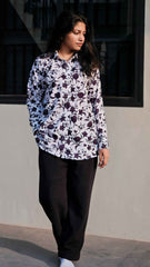 Women wearing black bell button pants women with floral printed top, ideal for casual outings