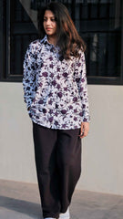 Trendy women in floral top paired with black bell button pants women for a stylish look