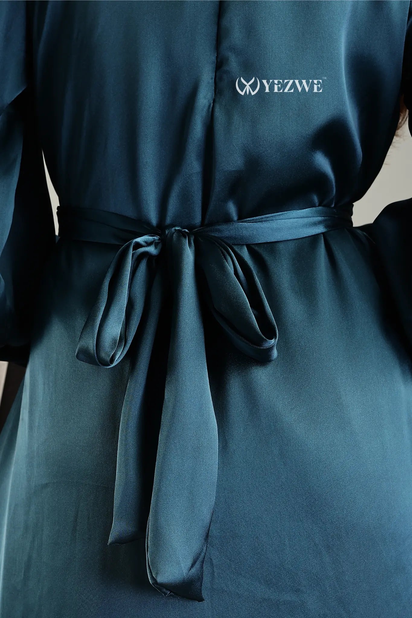 Blue satin flare modest gown from YEZWE featuring a stylish tied waist for a flattering fit