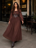 Beautiful woman in a brown corset maxi dress with long sleeves walking outside a café