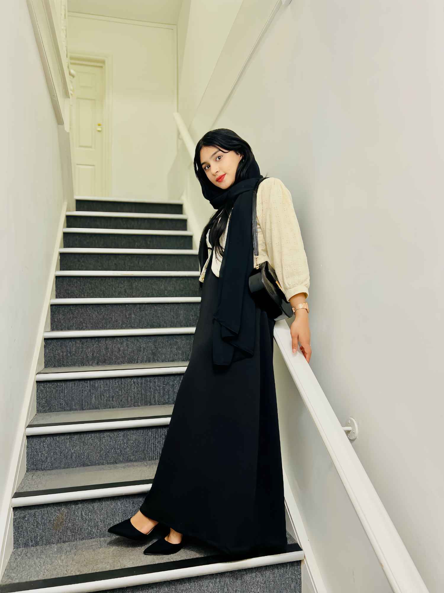 Yezwe Hakoba shrug with inner gown styled elegantly on a model posing on a staircase