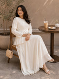 Woman in Ivory Faux Georgette Asymmetric Ruffle Maxi Dress sitting at a cafe table enjoying a drink