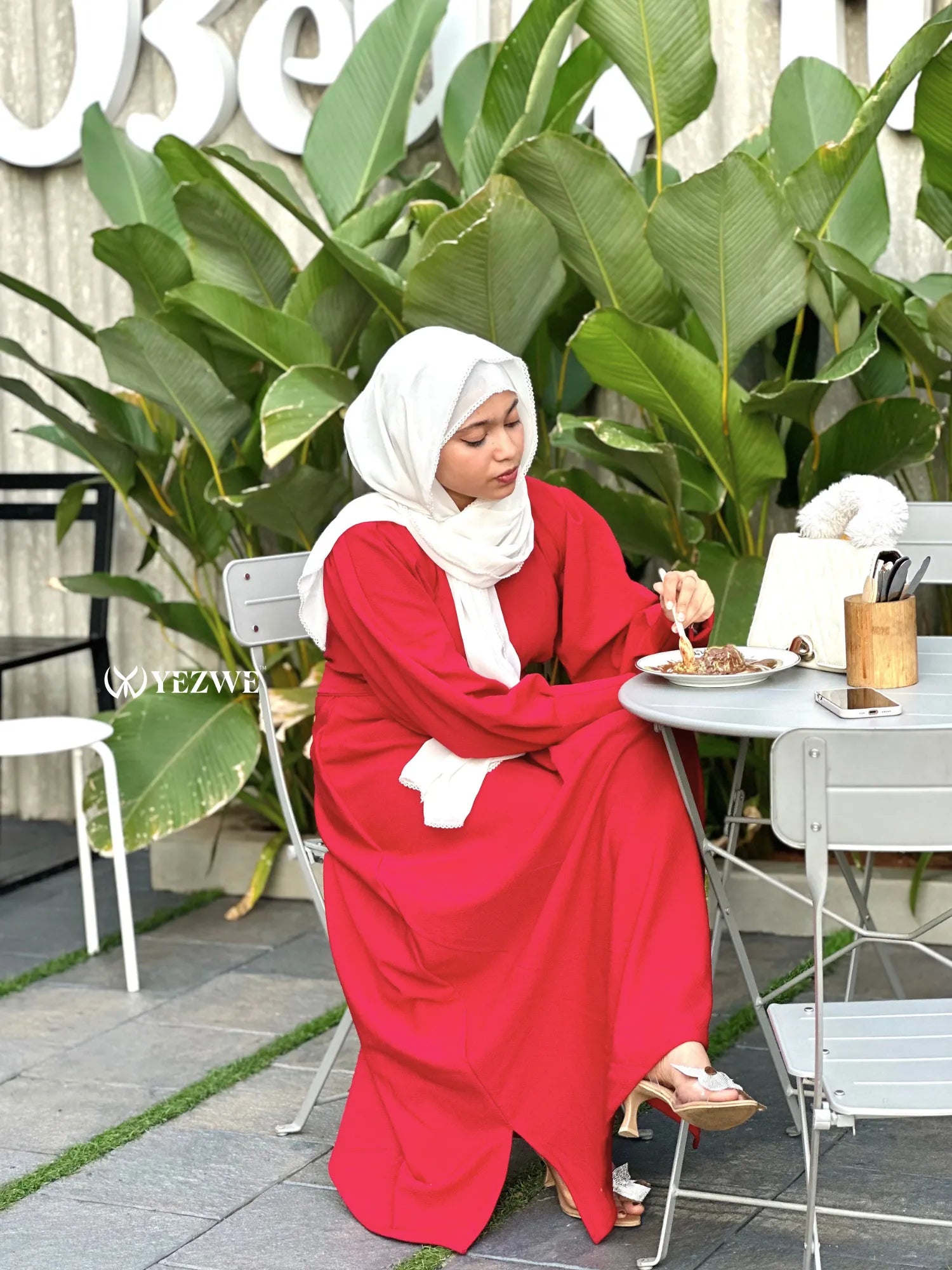 Red knitted Modest maxi dress for women styled elegantly at an outdoor setting