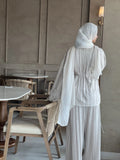 Back view of beige Korean pleated co-ord set for women with modest fit, featuring a flowy pleated top, matching pants, and hijab styling