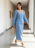 Woman walking wearing a light blue denim co-ord set with hakoba detailing, modest elegant outfit for daily wear