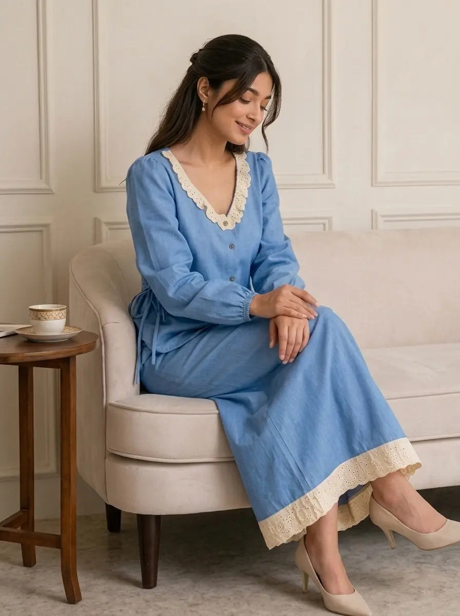 Woman sitting wearing a light blue denim co-ord set with hakoba detailing, modest elegant outfit for everyday wear