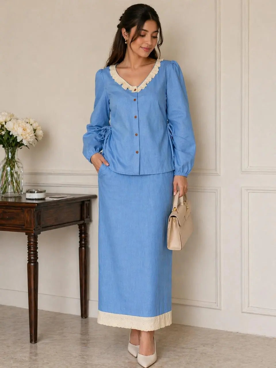 Woman wearing a light blue denim co-ord set with hakoba detailing, modest elegant outfit for daily wear