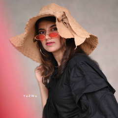 Stylish woman wearing a modest black co-ord set with a wide-brimmed hat and sunglasses