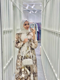 Modest brown maxi dress with floral print, perfect for elegant occasions and casual outings