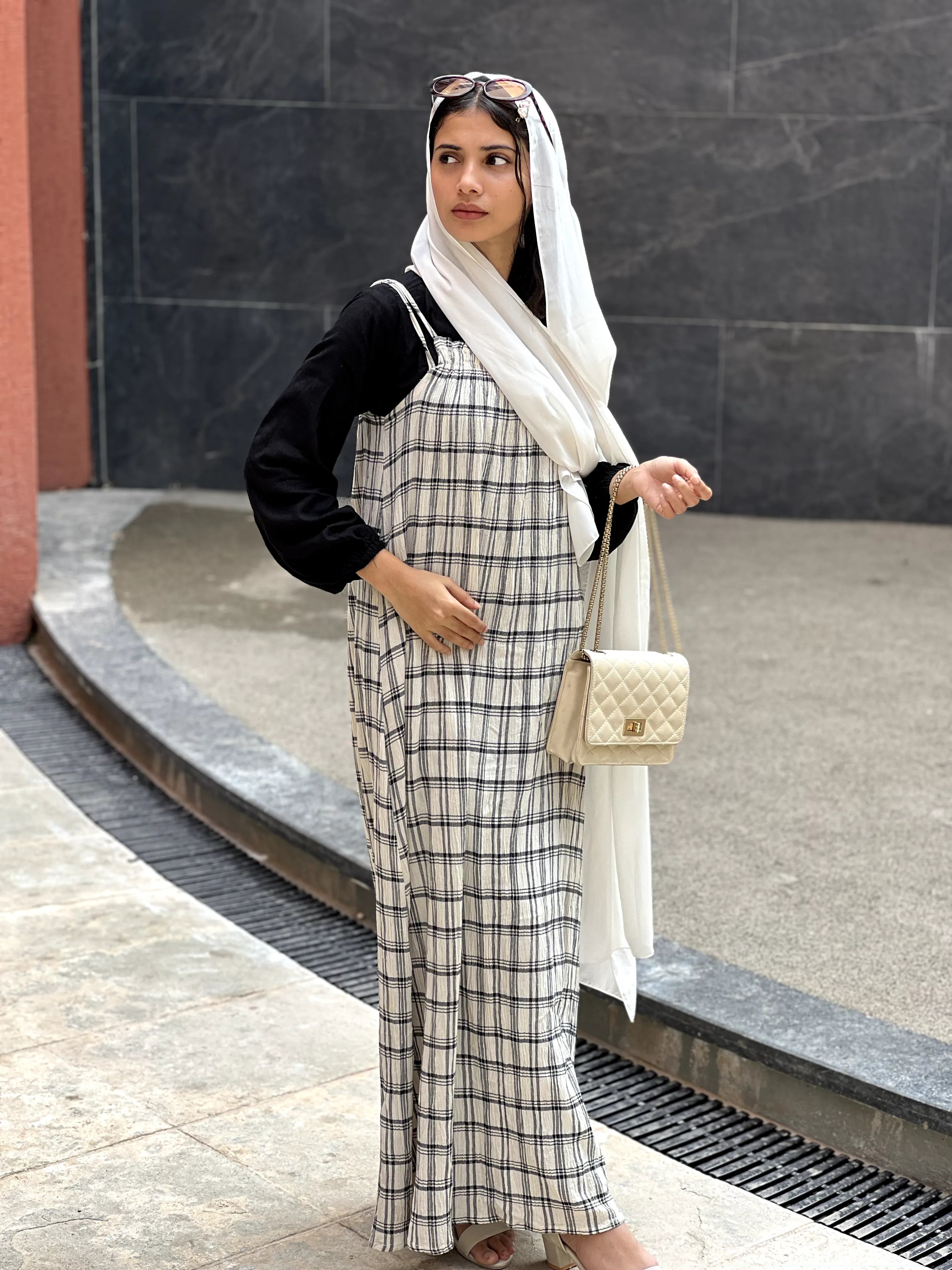 Yezwe modest dungaree dress in plaid pattern, styled with a black top and white scarf