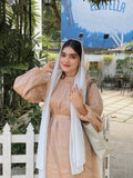 Yezwe modest golden beige maxi dress styled with white accessories in a garden setting