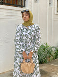 Modest green leaf maxi dress by Yezwe featuring a button-up design and long sleeves