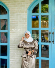 Modest olive satin co-ord set styled with a matching hijab in an elegant outdoor setting