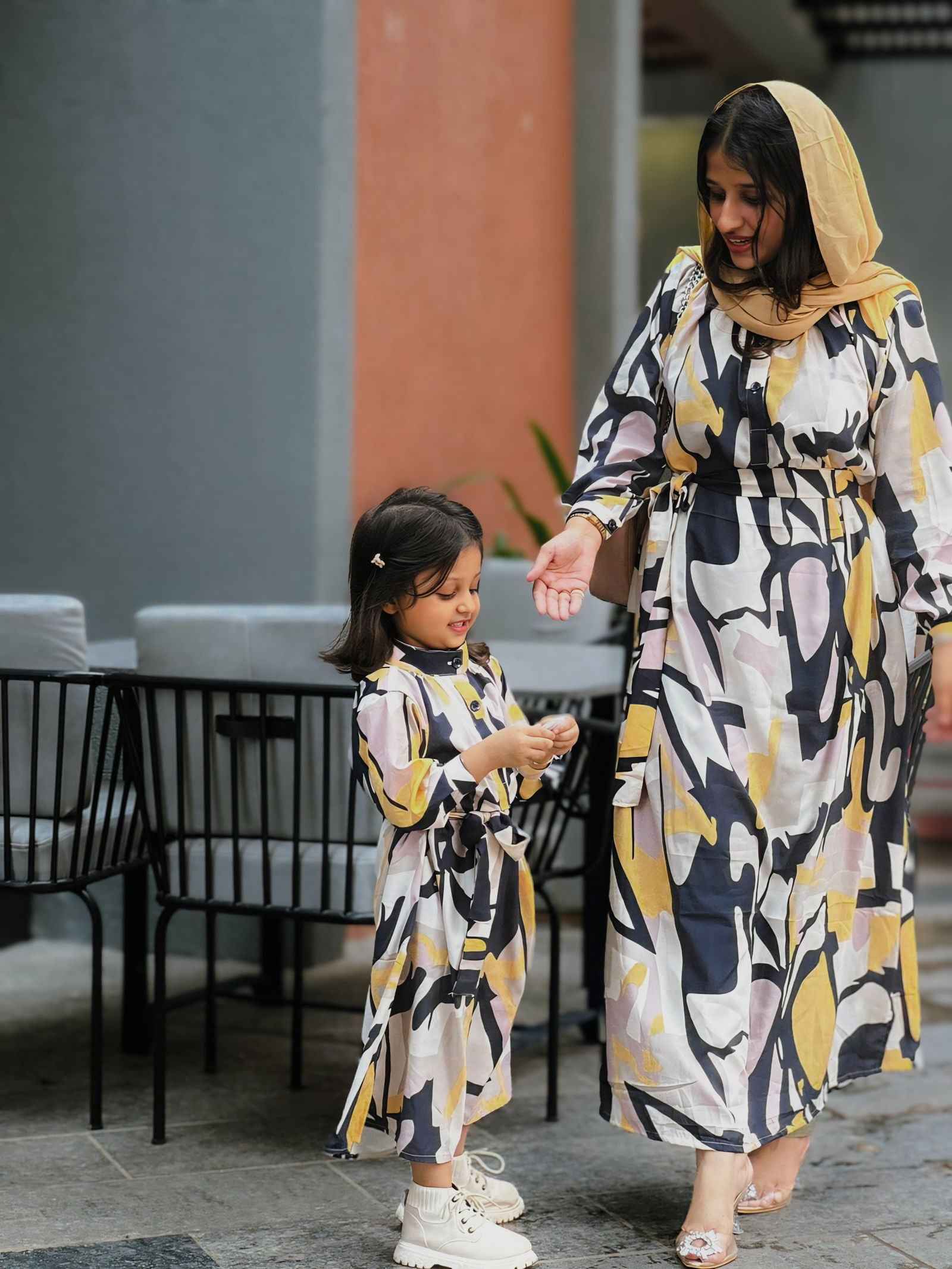 Yezwe modest open front dress in abstract design worn by a woman with a child in matching outfits