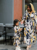 Yezwe modest open front dress in abstract design worn by a woman with a child in matching outfits