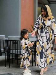 Yezwe modest open front dress in abstract design worn by a woman with a child in matching outfits