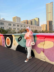 Modest oversized co-ord set featuring a pink top and white pants, styled for a chic outdoor look