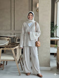 Woman wearing a beige striped co-ord set with long sleeves and wide pants, styled with a hijab for a modest and elegant everyday look