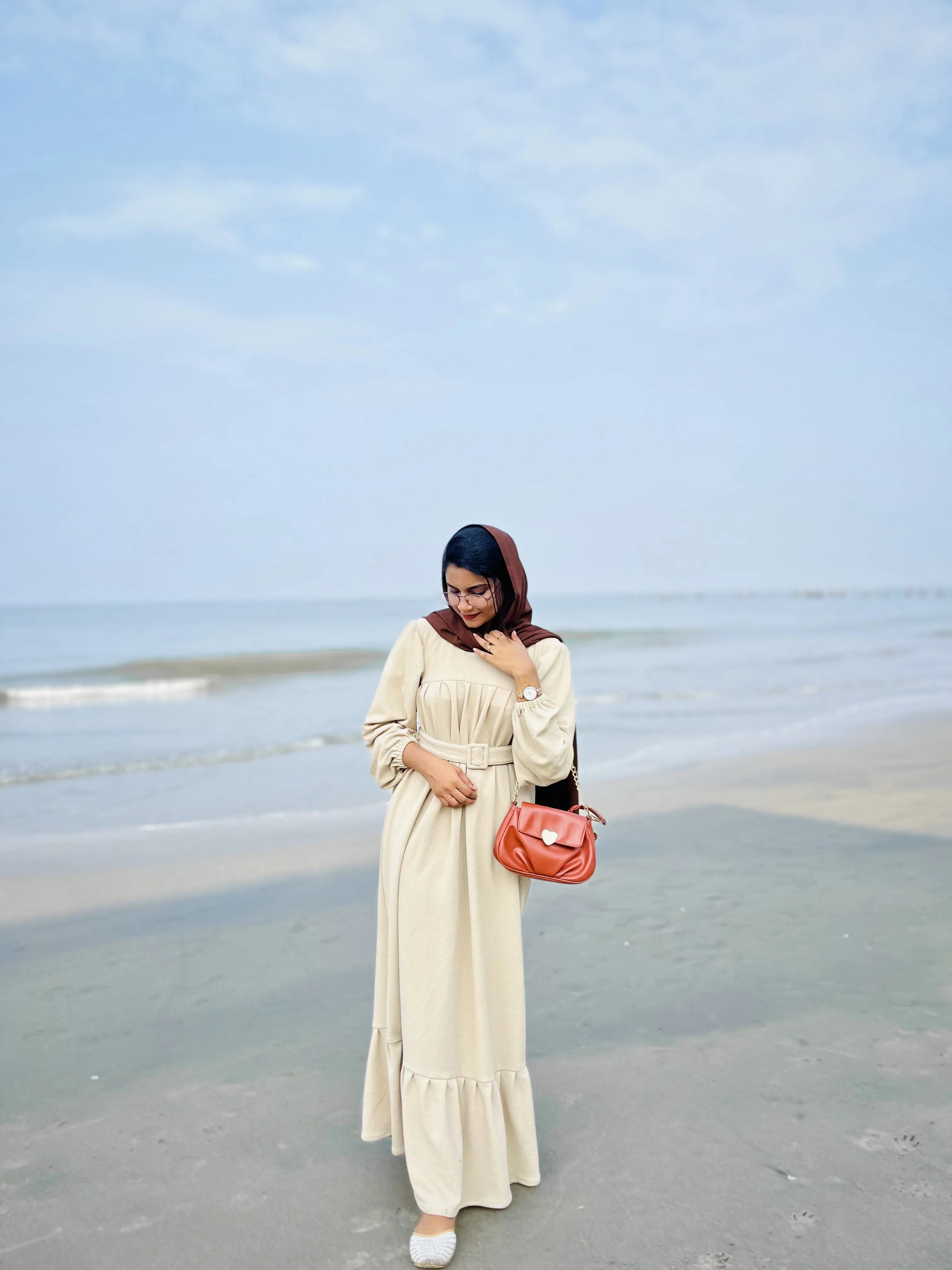 Yezwe Modest Wear Dress in Beige with Long Sleeves and Flowy Hem at the Beach