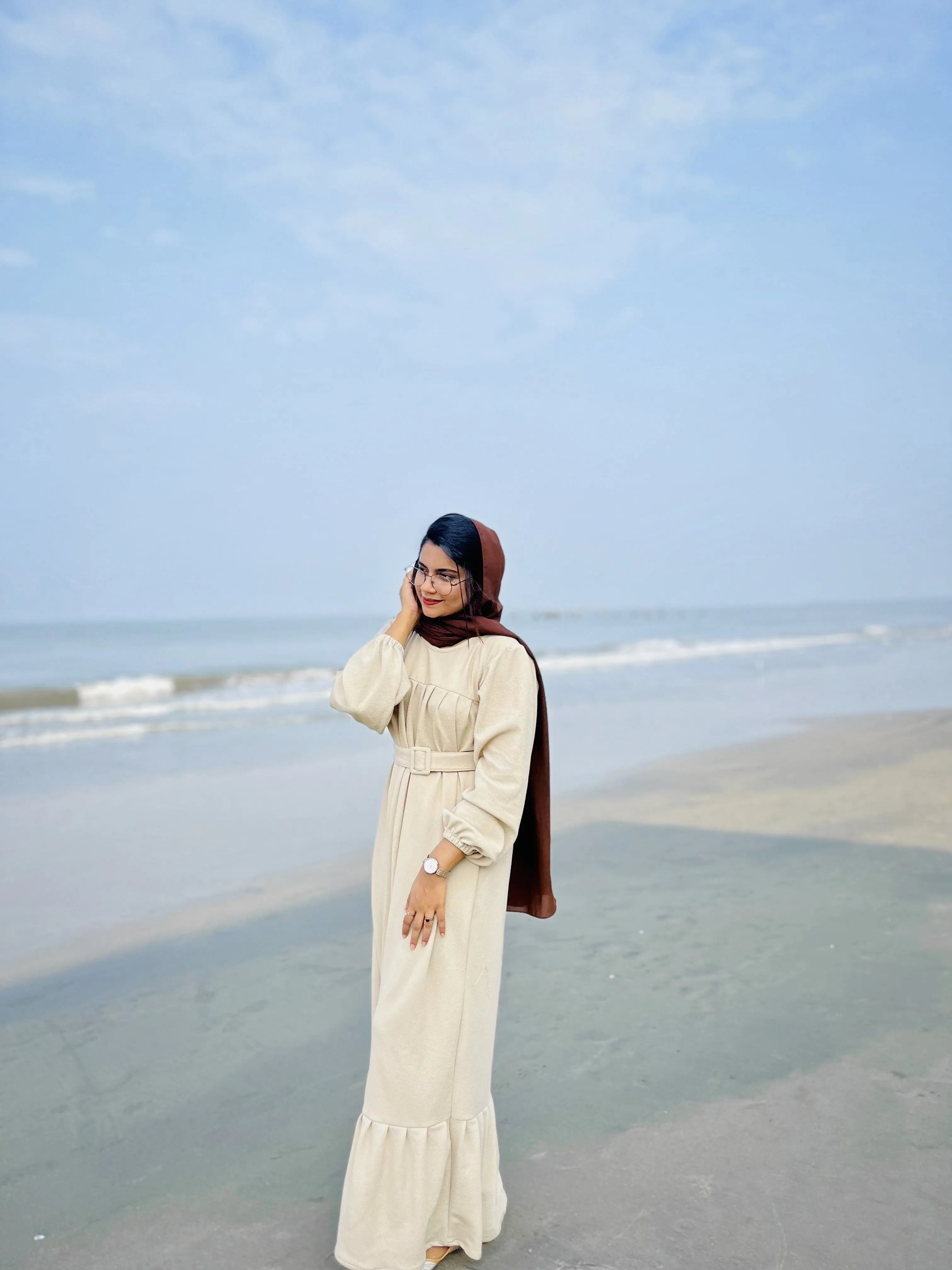 Yezwe Modest Wear Dress in beige, featuring a flowy design and ruffle hem, perfect for beach outings