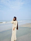 Yezwe Modest Wear Dress in beige, featuring a flowy design and ruffle hem, perfect for beach outings